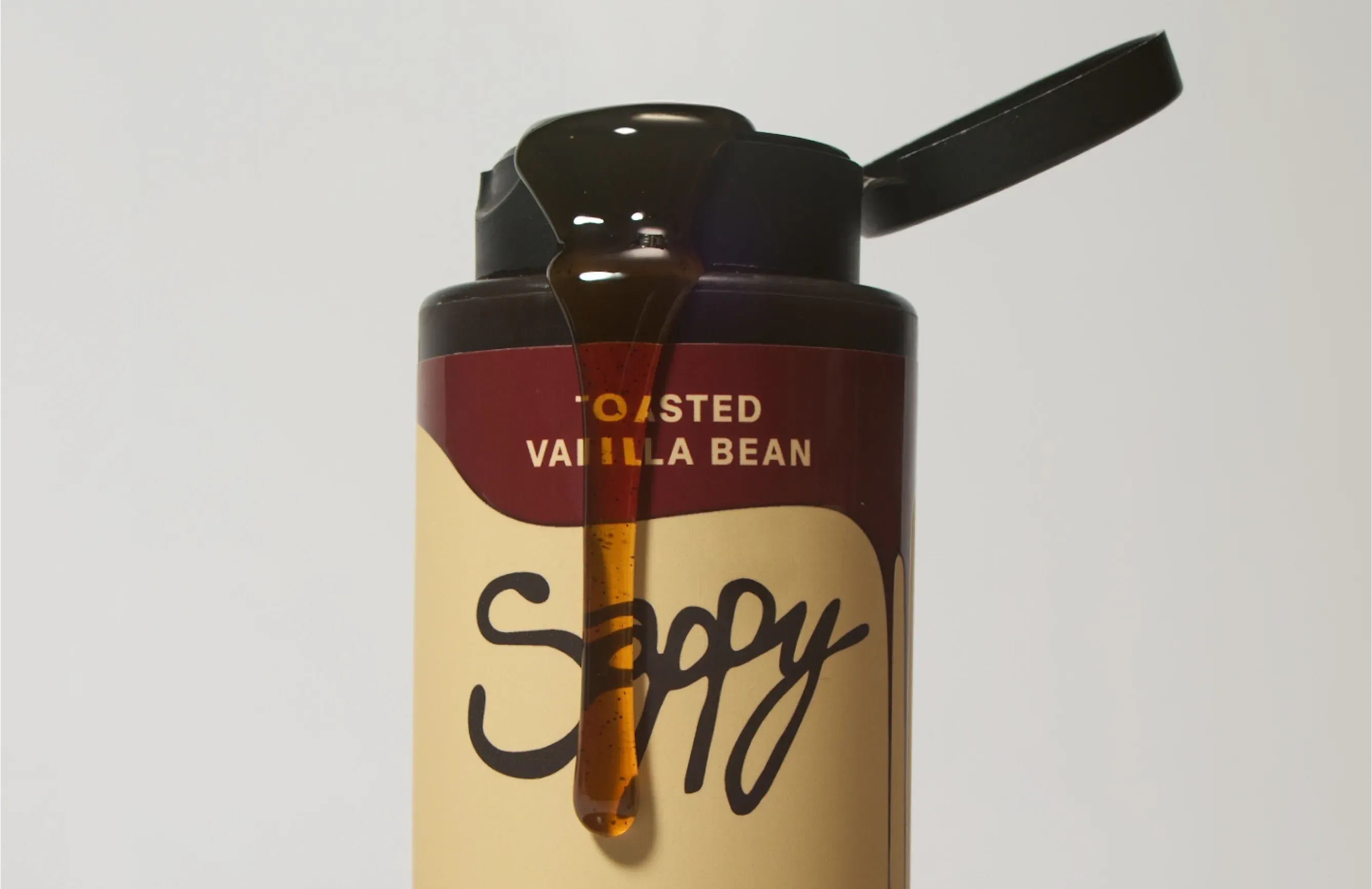 Sappy toasted vanilla bean syrup pouring from the bottle