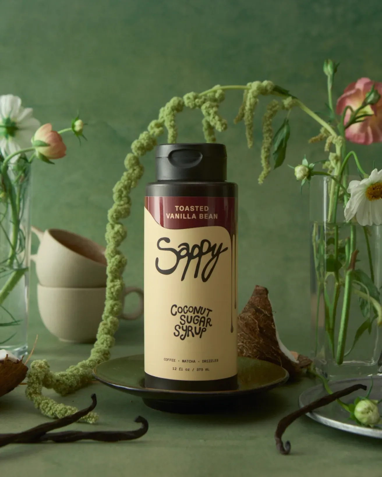 Sappy coconut sugar syrup bottle among flowers