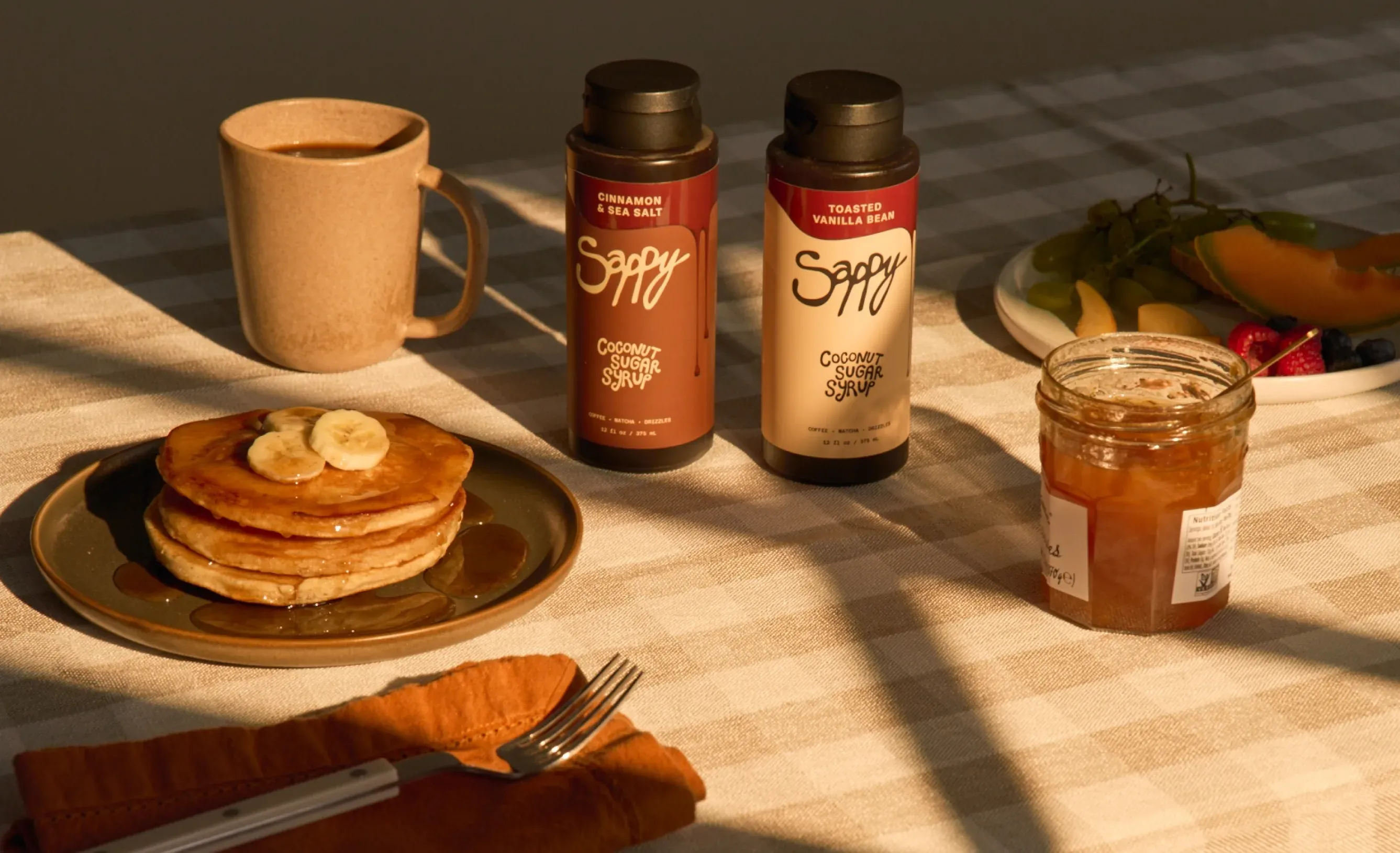 Breakfast table with pancakes and Sappy syrup bottles