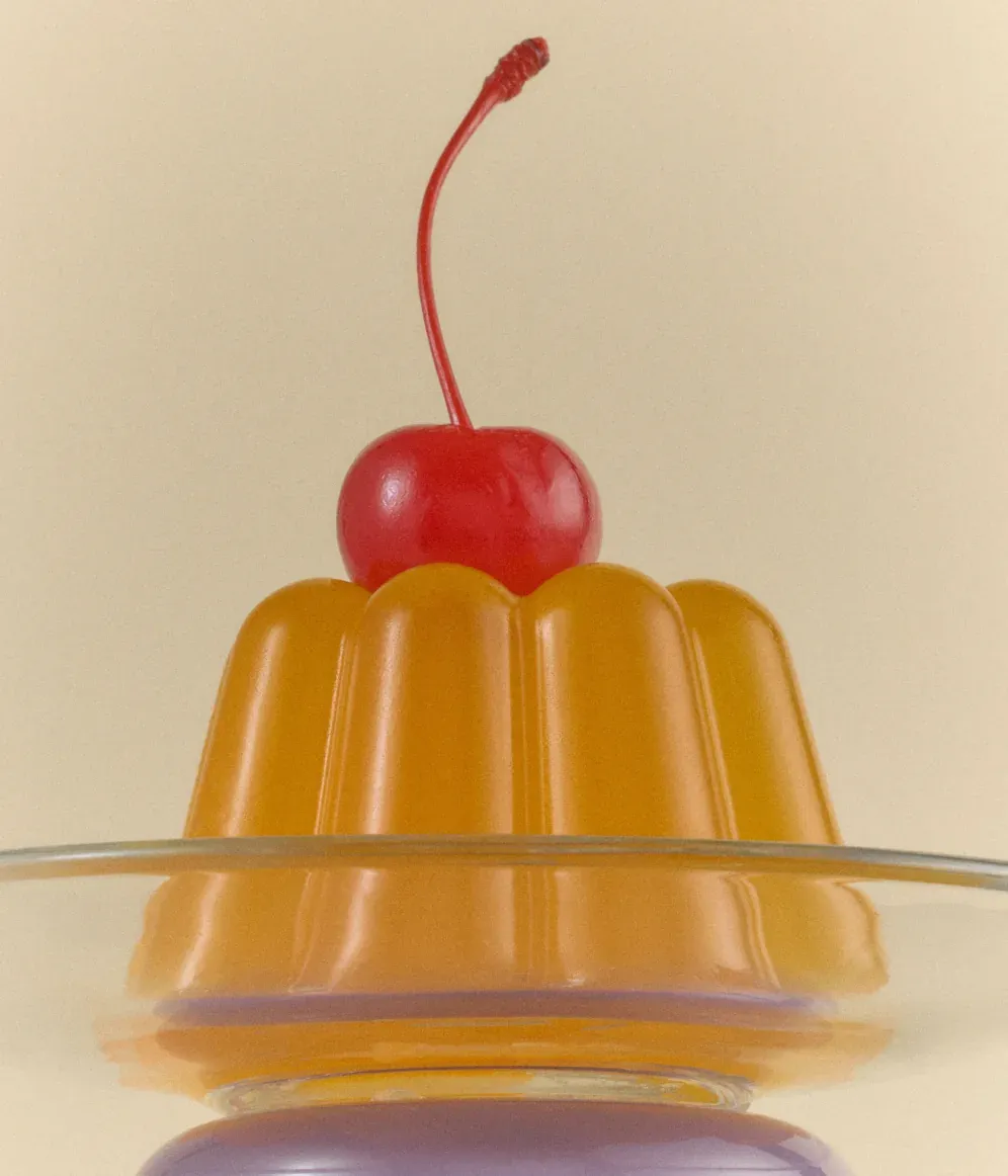 Orange gelatin dessert with a cherry on top