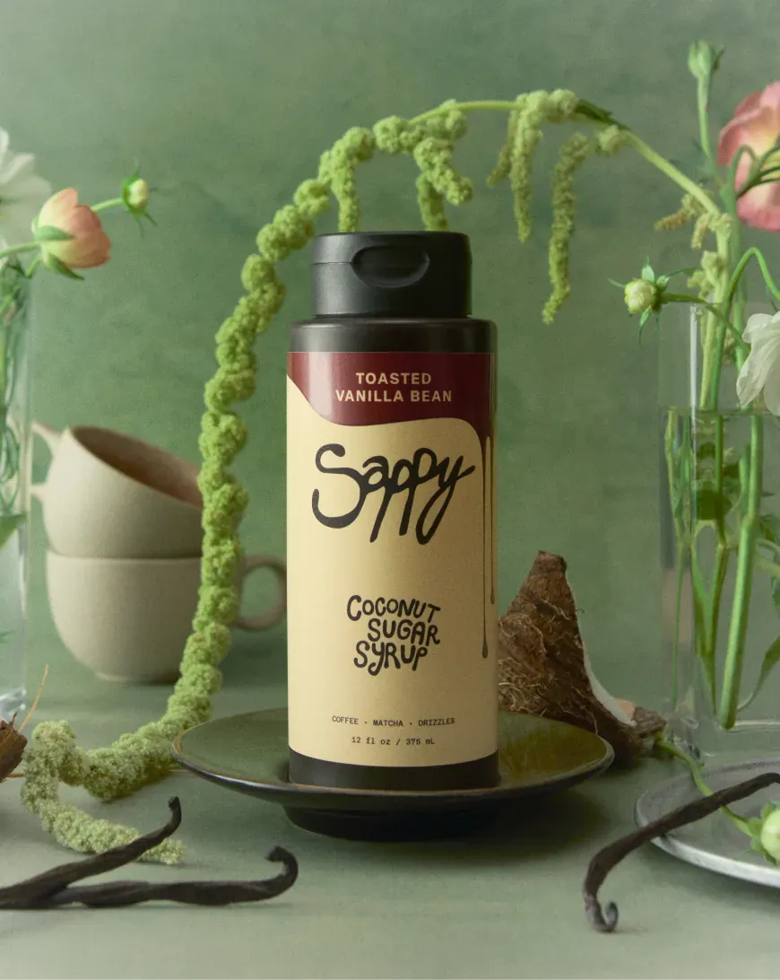 Sappy coconut sugar syrup bottle among flowers